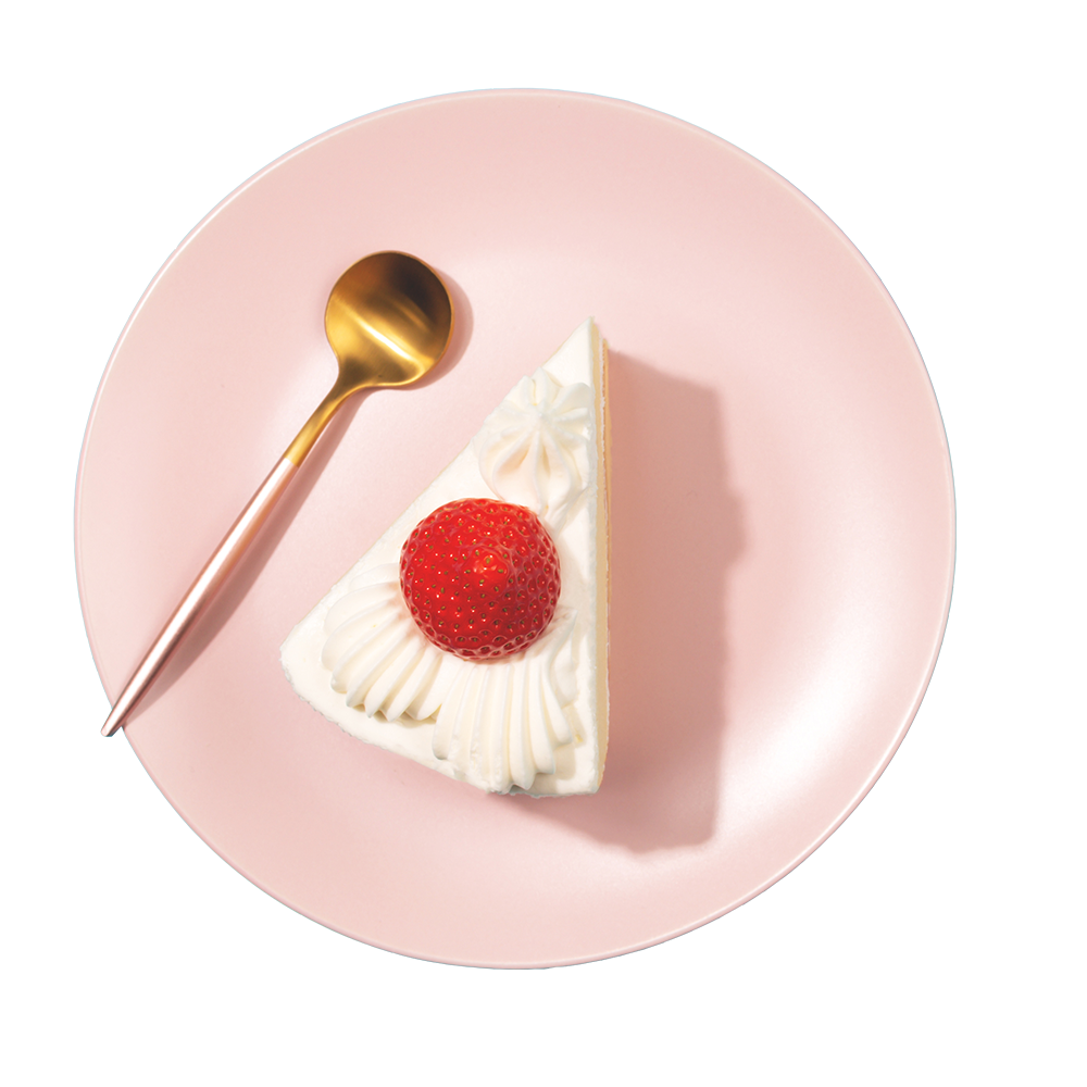 pink plate with cheesecake with a strawberry on top